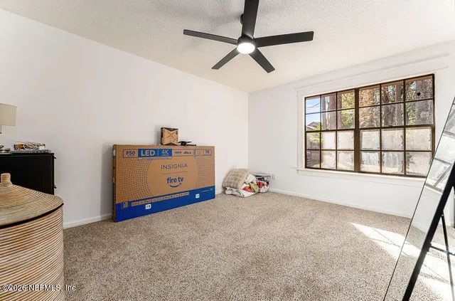 a view of a room with toys and a ceiling fan