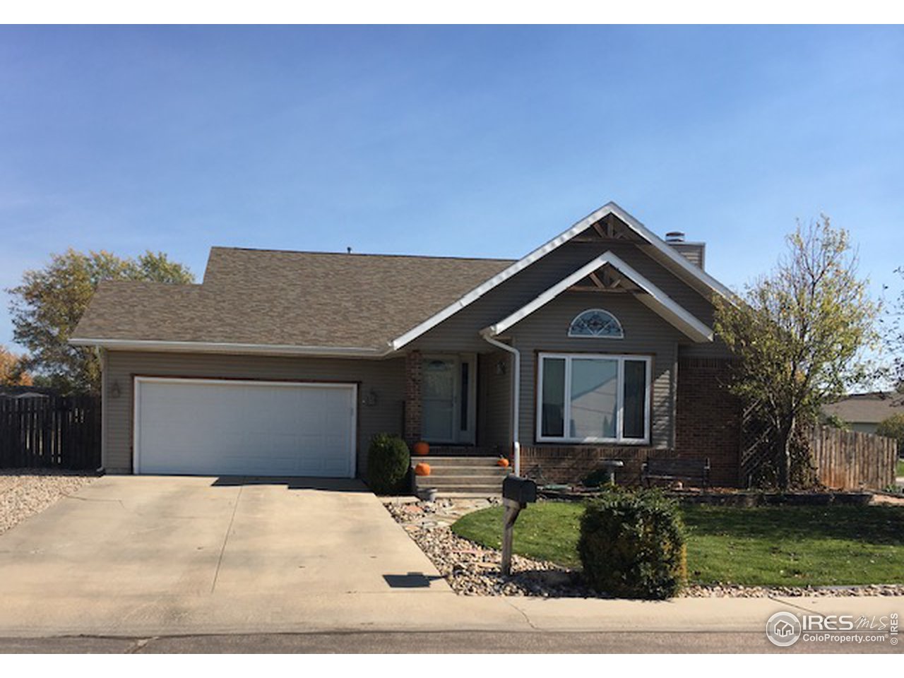 1821 Robin Road Sterling, CO 80751 - Photo 2 of 12 a front view of a house with garden