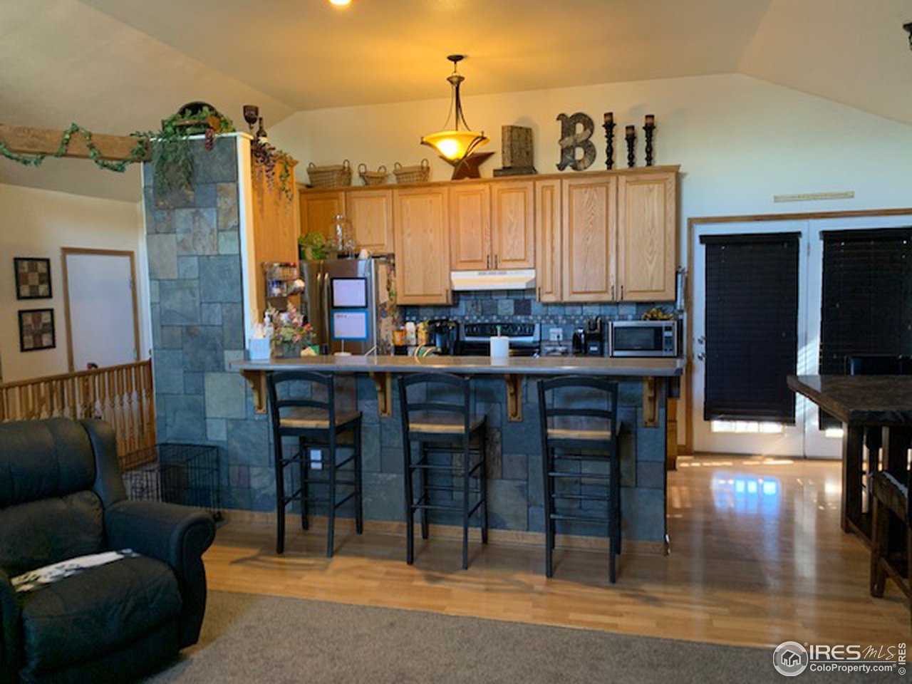 1821 Robin Road Sterling, CO 80751 - Photo 4 of 12 a kitchen with a dining table chairs and a refrigerator