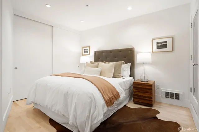 a bedroom with bed and a night stand