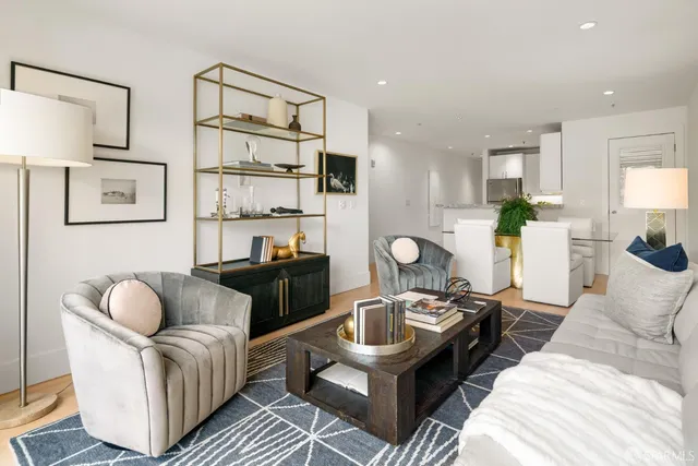 a living room with furniture ceiling fan and a rug