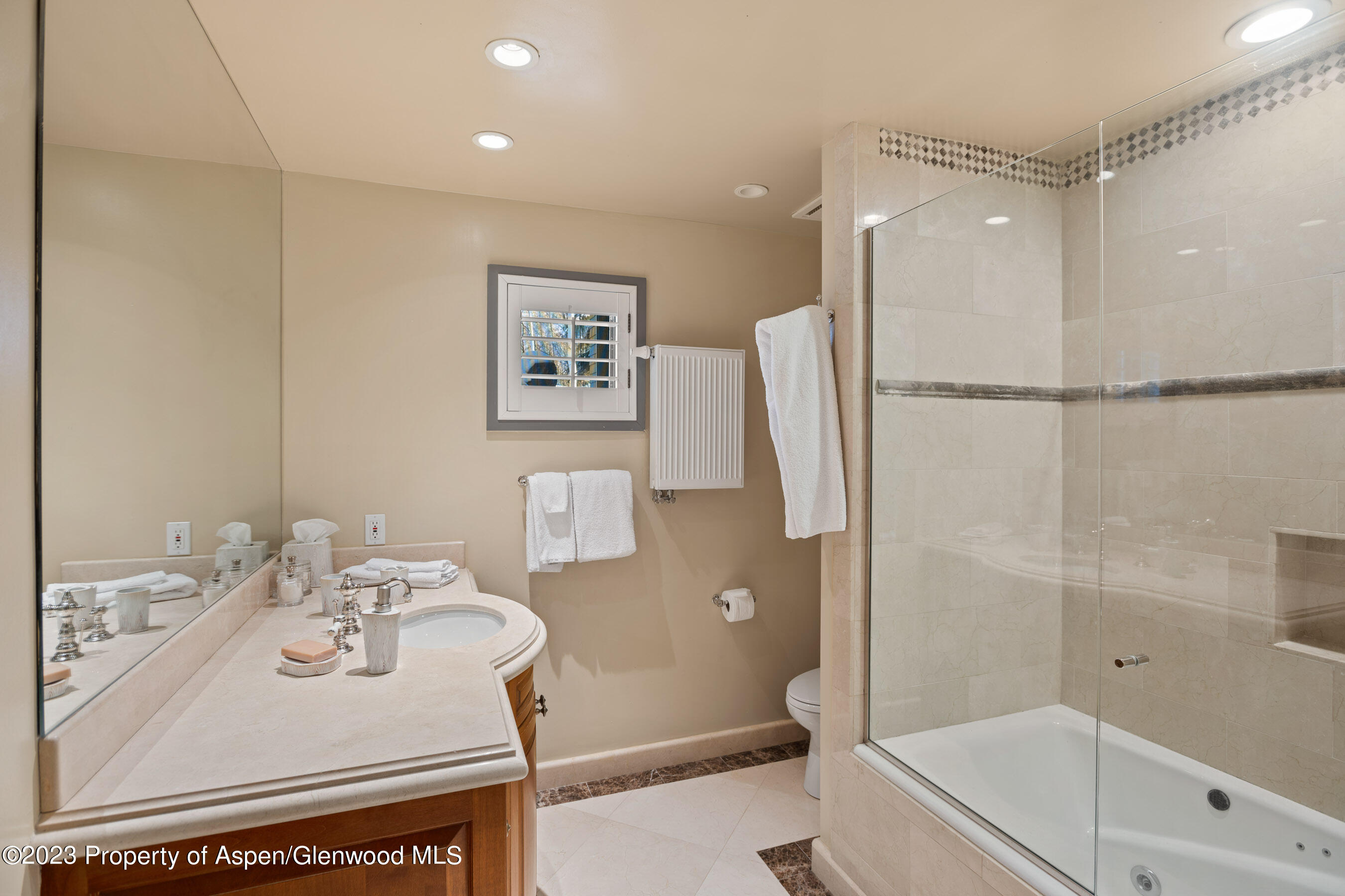 1402 Crystal Lake Road Aspen, CO 81611 - Photo 13 of 22 a bathroom with a sink a mirror and a bathtub