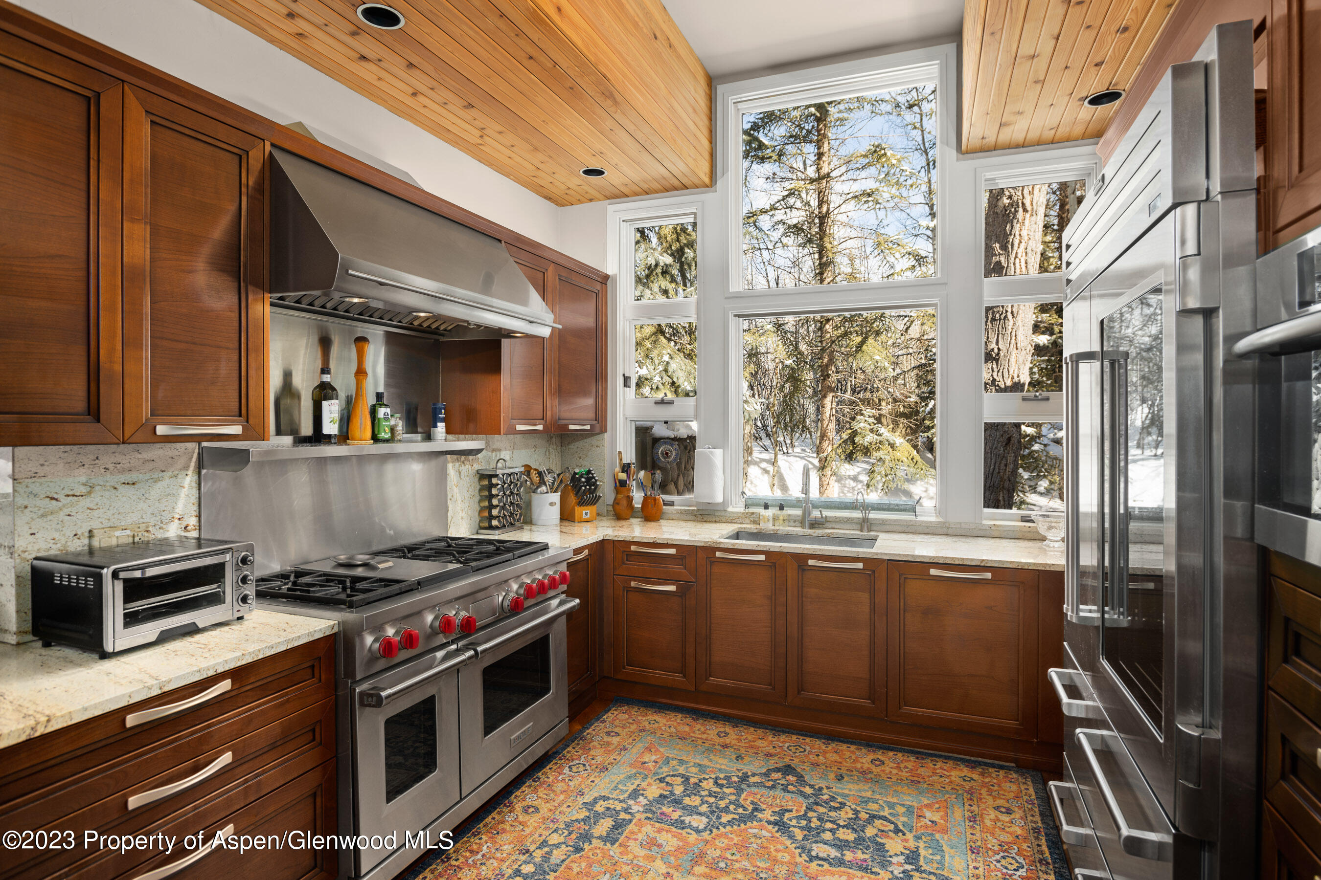 1402 Crystal Lake Road Aspen, CO 81611 - Photo 6 of 22 a kitchen with stainless steel appliances granite countertop a stove and a sink