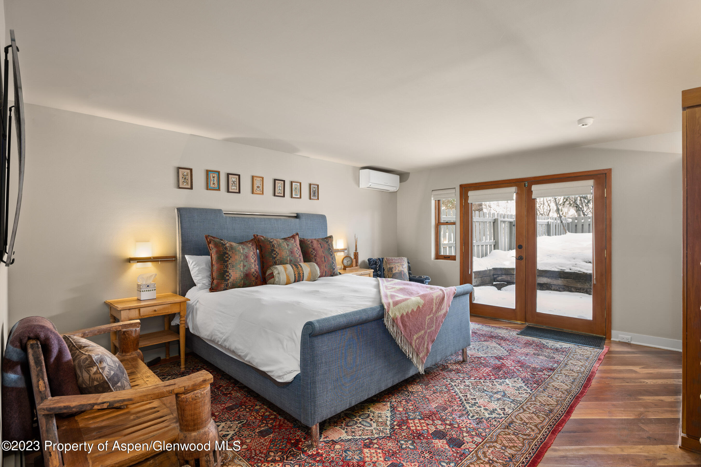 1402 Crystal Lake Road Aspen, CO 81611 - Photo 10 of 22 a bedroom with a bed and wooden floor