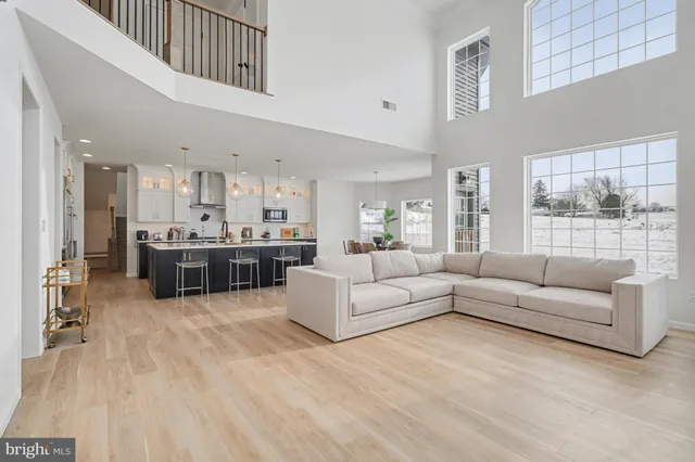 a living room with furniture and kitchen view