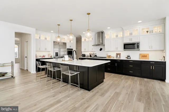 a kitchen with stainless steel appliances kitchen island granite countertop a sink counter space and cabinets