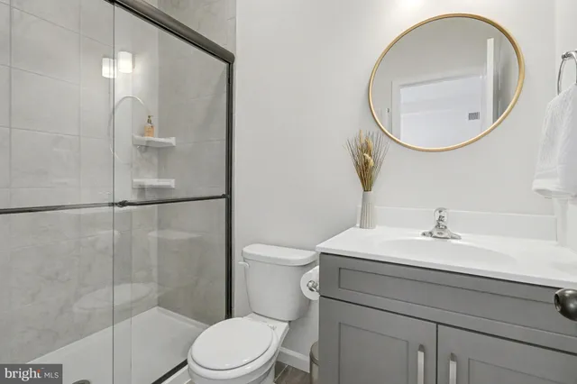 a bathroom with a sink toilet and a mirror