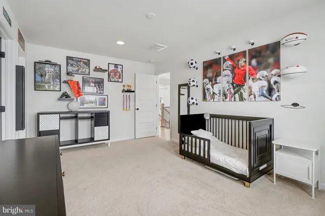 a view of a hallway with workspace and lots of furniture