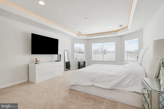 a bedroom with a flat screen television and a bed