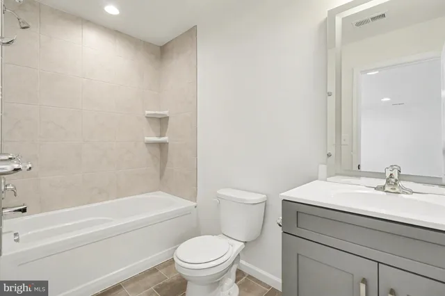 a bathroom with a sink toilet and vanity