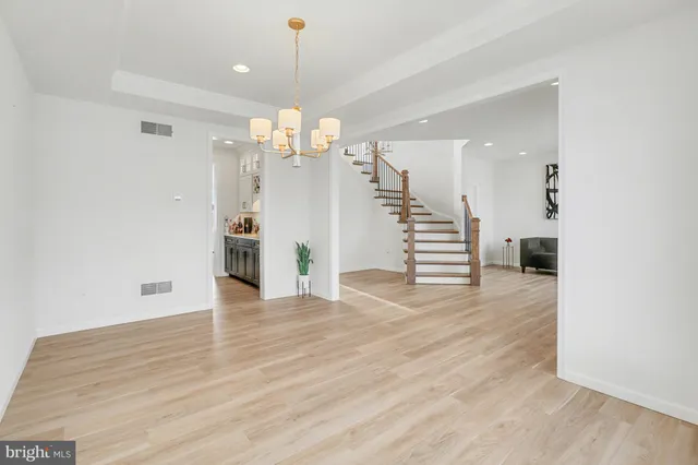 a view of a livingroom with wooden floor and stairs