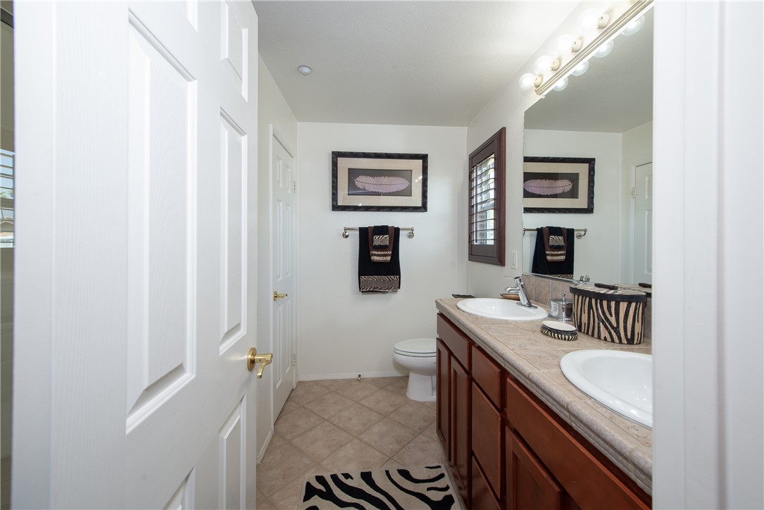 7353 Ellena W, Unit 52 Rancho Cucamonga, CA 91730 - Photo 16 of 30 The attached primary ensuite has dual sinks and a full size linen closet.
