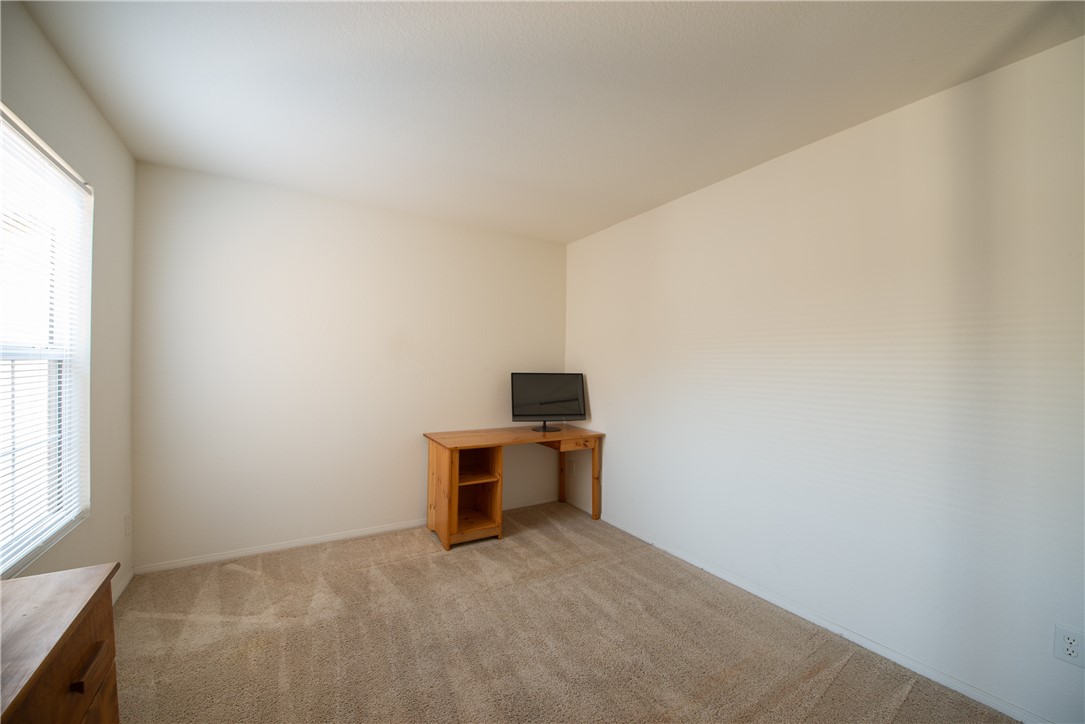 7353 Ellena W, Unit 52 Rancho Cucamonga, CA 91730 - Photo 21 of 30 Bedroom 2 has a large window that overlooks the courtyard.