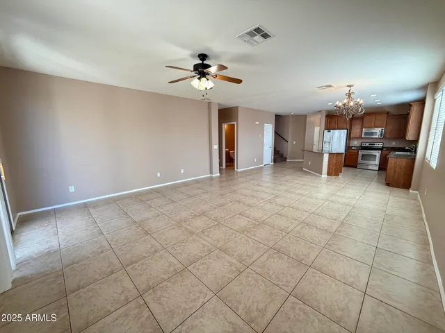 a view of a livingroom with a furniture and chandelier fan