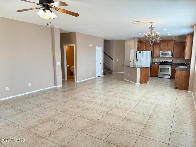 a view of a kitchen with a sink and a chandelier