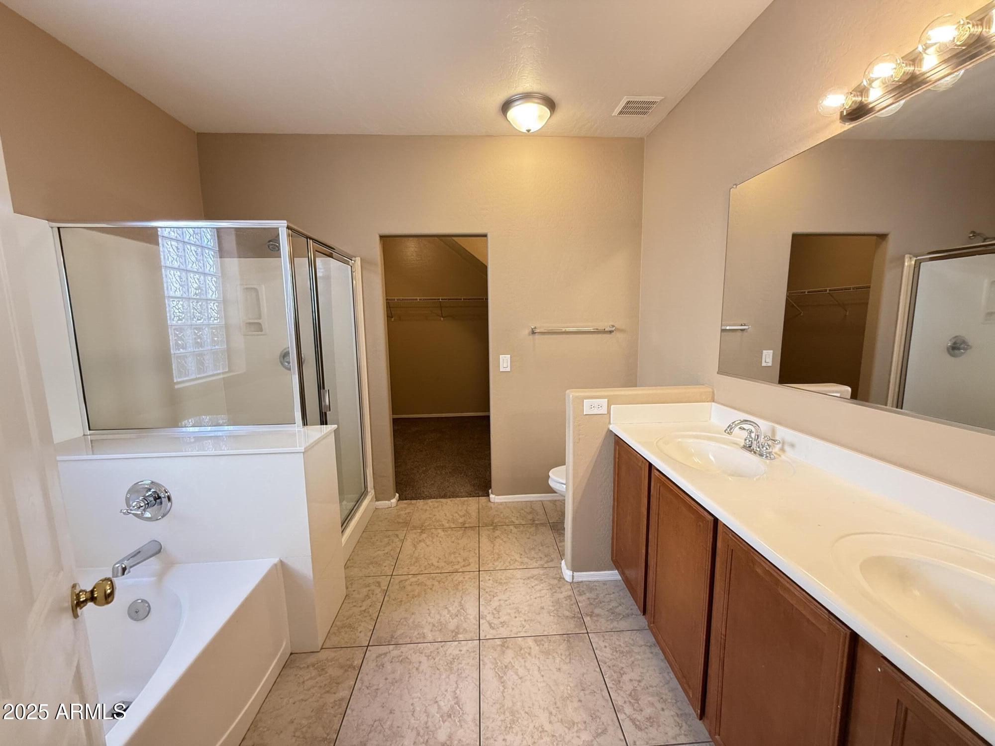 11752 West Foothill Drive Sun City, AZ 85373 - Photo 19 of 48 a bathroom with a tub sink and mirror