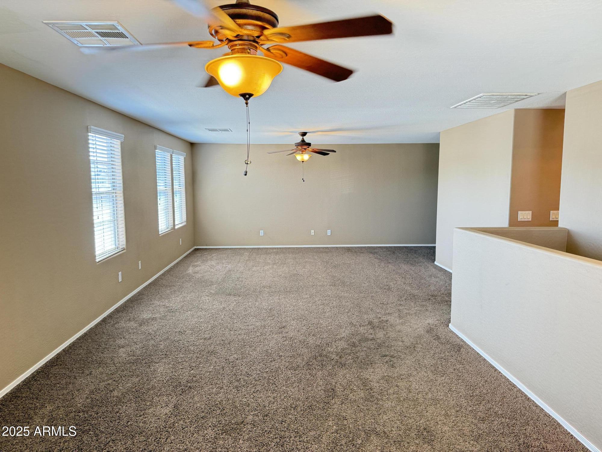 11752 West Foothill Drive Sun City, AZ 85373 - Photo 27 of 48 wooden floor in an empty room with a window
