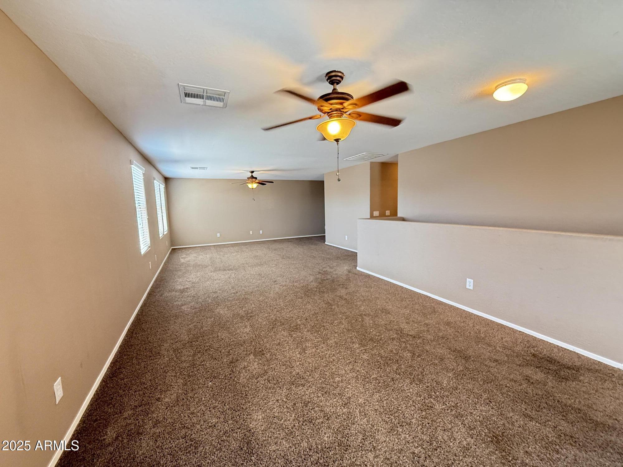 11752 West Foothill Drive Sun City, AZ 85373 - Photo 28 of 48 wooden floor in an empty room with a window