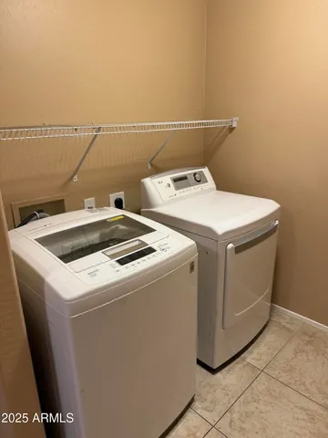 an empty room with a window and a chandelier fan
