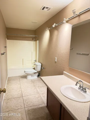 a bathroom with a sink vanity and a mirror
