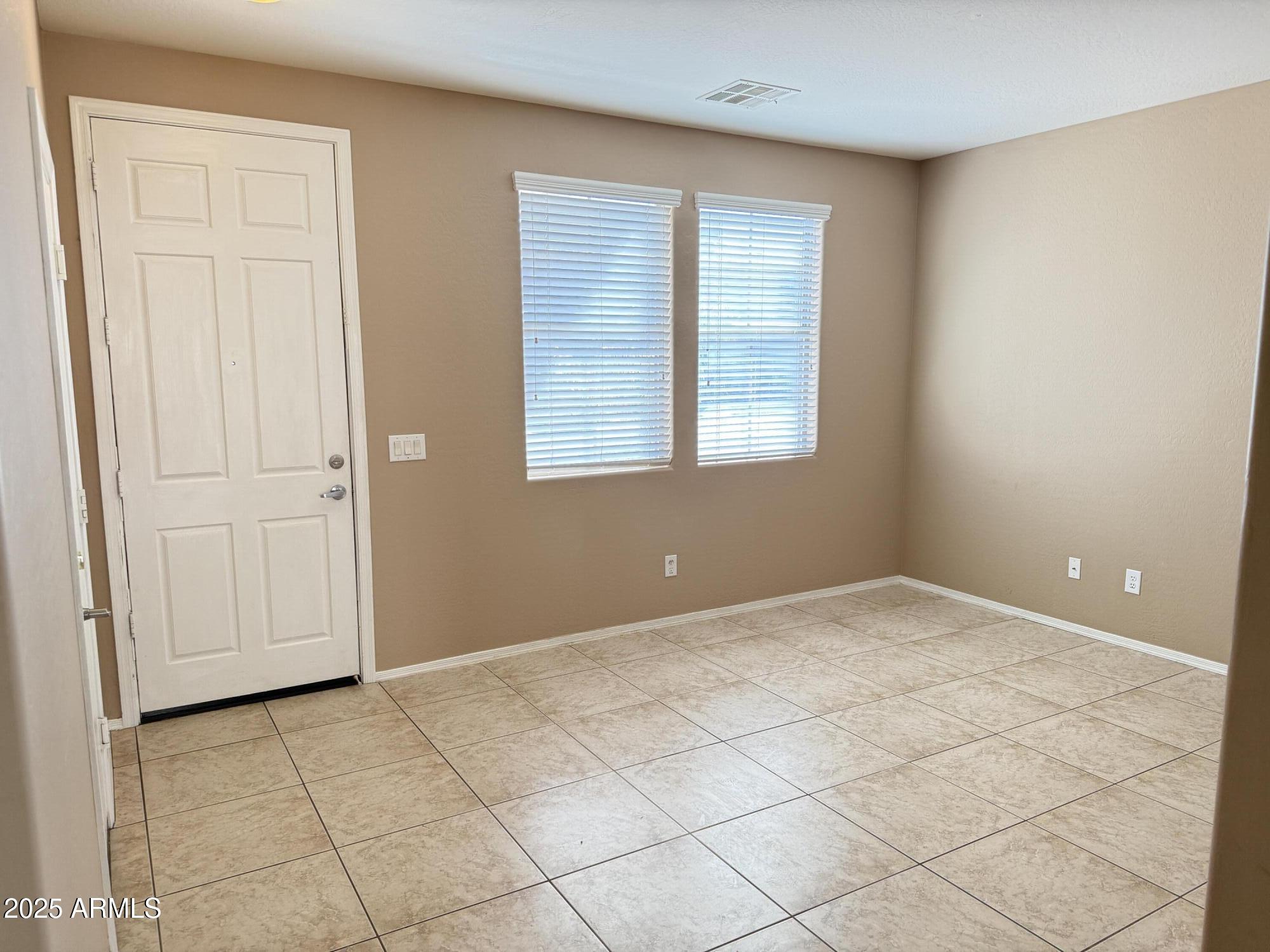 11752 West Foothill Drive Sun City, AZ 85373 - Photo 4 of 48 an empty room with windows