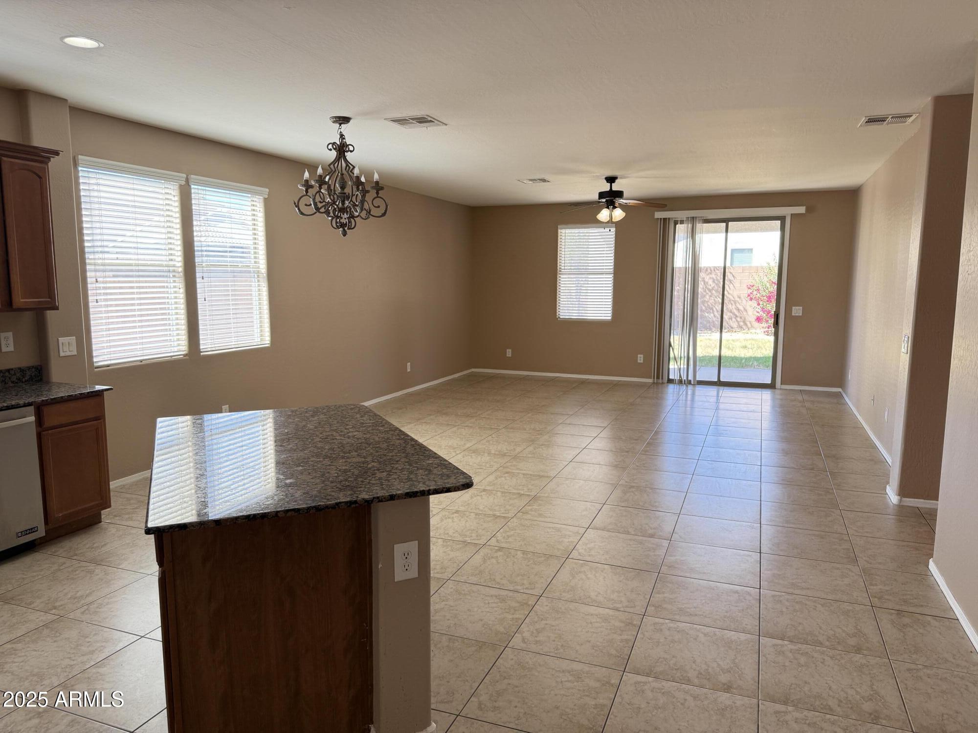 11752 West Foothill Drive Sun City, AZ 85373 - Photo 6 of 48 a view of a livingroom with a chandelier furniture and windows