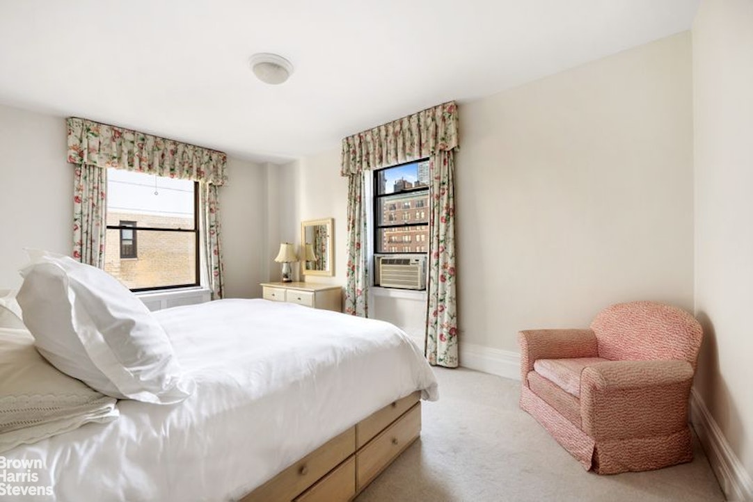 150 East 73rd Street, Unit 11B Manhattan, NY 10021 - Photo 6 of 12 a bedroom with a bed and a couch