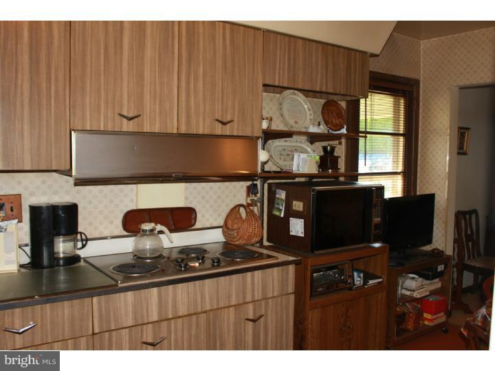 118 Harned Road Springfield, PA 19064 - Photo 14 of 25 a kitchen with a stove and a refrigerator