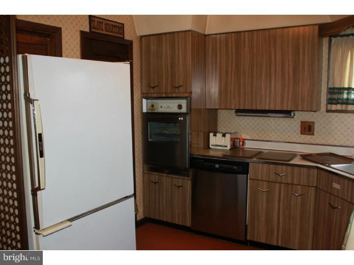 118 Harned Road Springfield, PA 19064 - Photo 15 of 25 a kitchen with a refrigerator and cabinets
