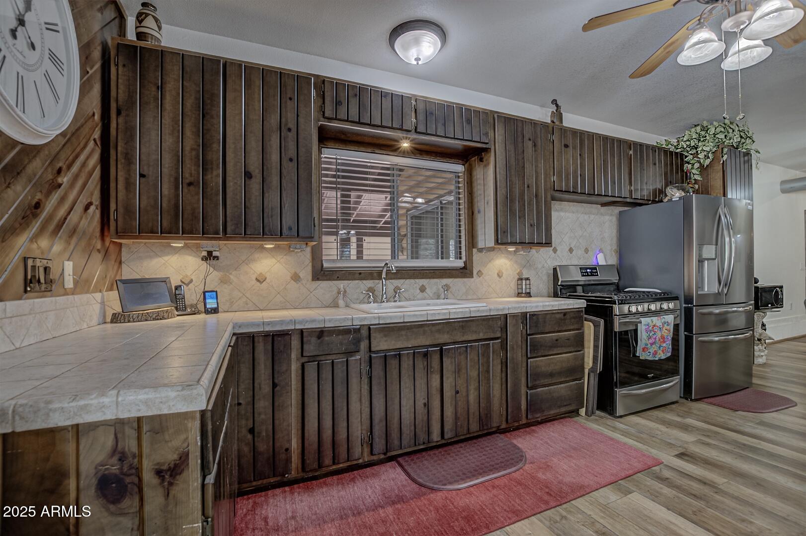 1103 East Ranch Road Payson, AZ 85541 - Photo 11 of 74 a kitchen with stainless steel appliances granite countertop a sink refrigerator and cabinets