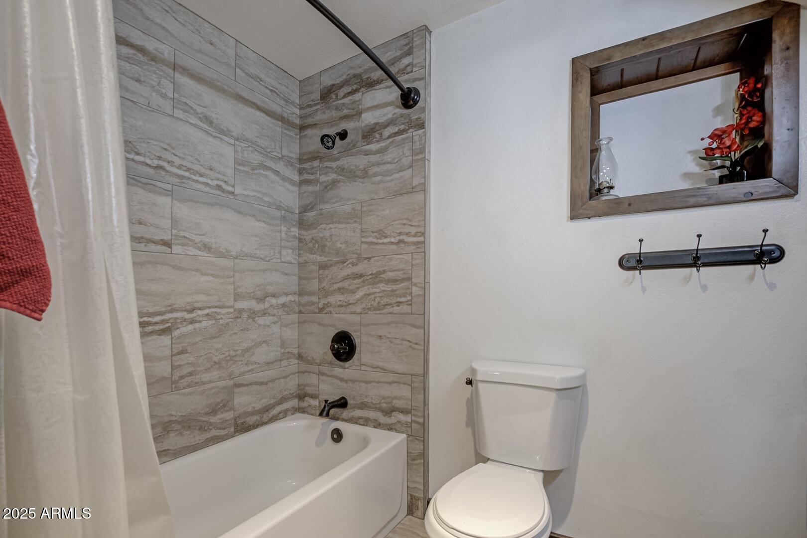 1103 East Ranch Road Payson, AZ 85541 - Photo 27 of 74 a bathroom with a toilet and a shower curtain