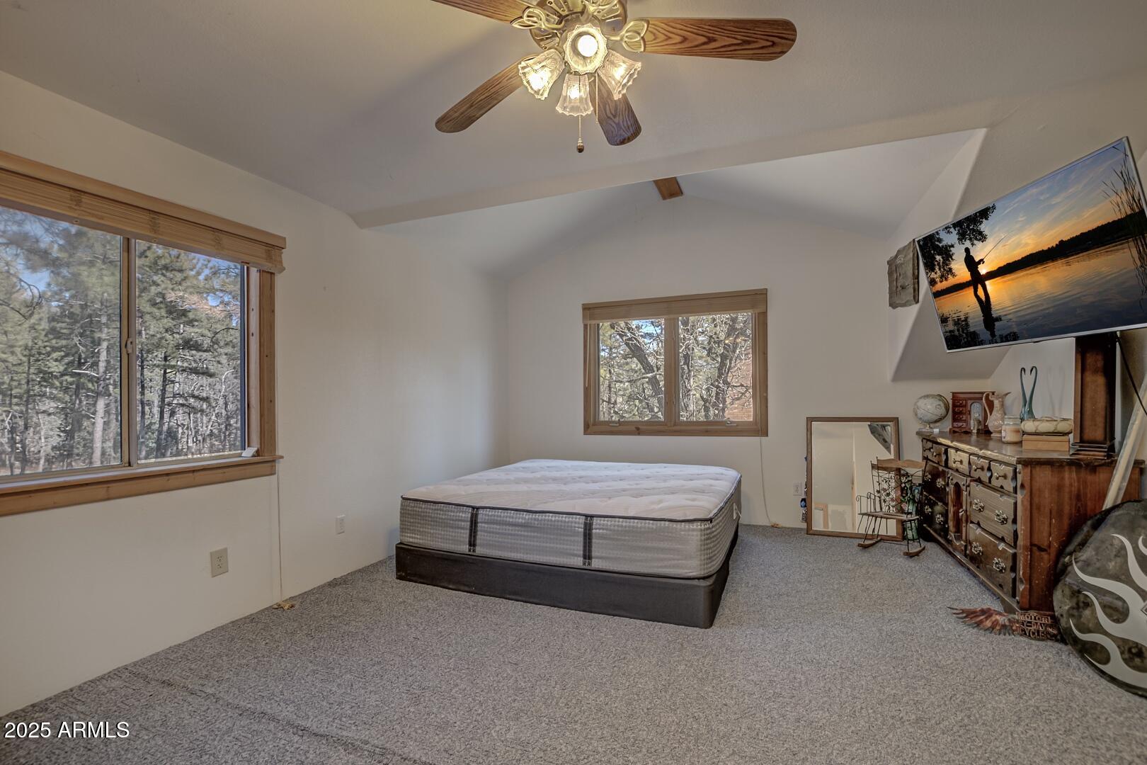 1103 East Ranch Road Payson, AZ 85541 - Photo 32 of 74 a spacious bedroom with a bed and a chandelier