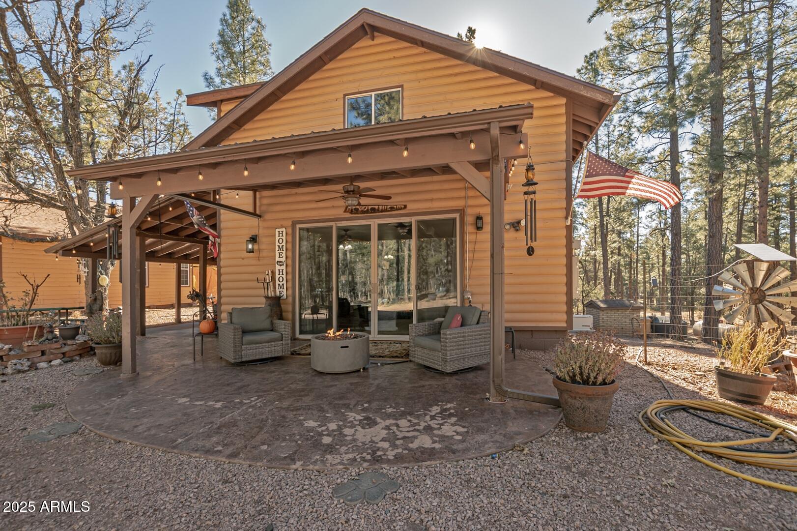 1103 East Ranch Road Payson, AZ 85541 - Photo 43 of 74 a view of a patio with table and chairs potted plants and a large tree