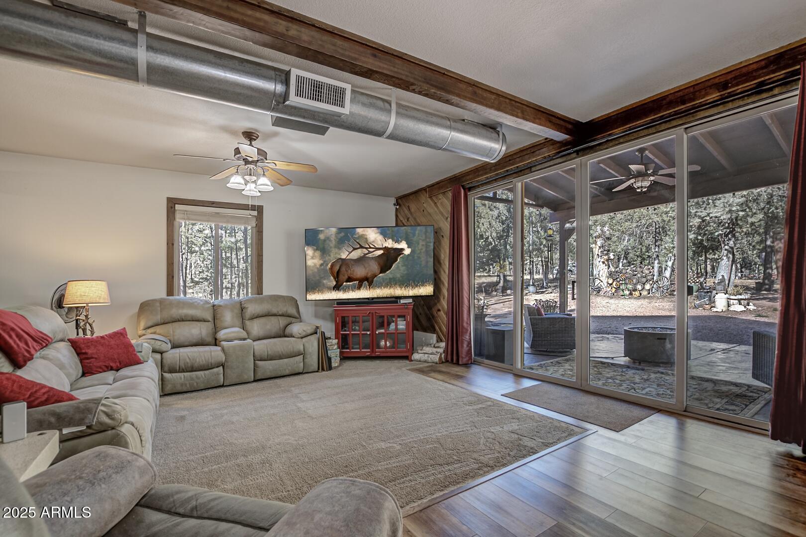 1103 East Ranch Road Payson, AZ 85541 - Photo 9 of 74 a living room with furniture and a floor to ceiling window