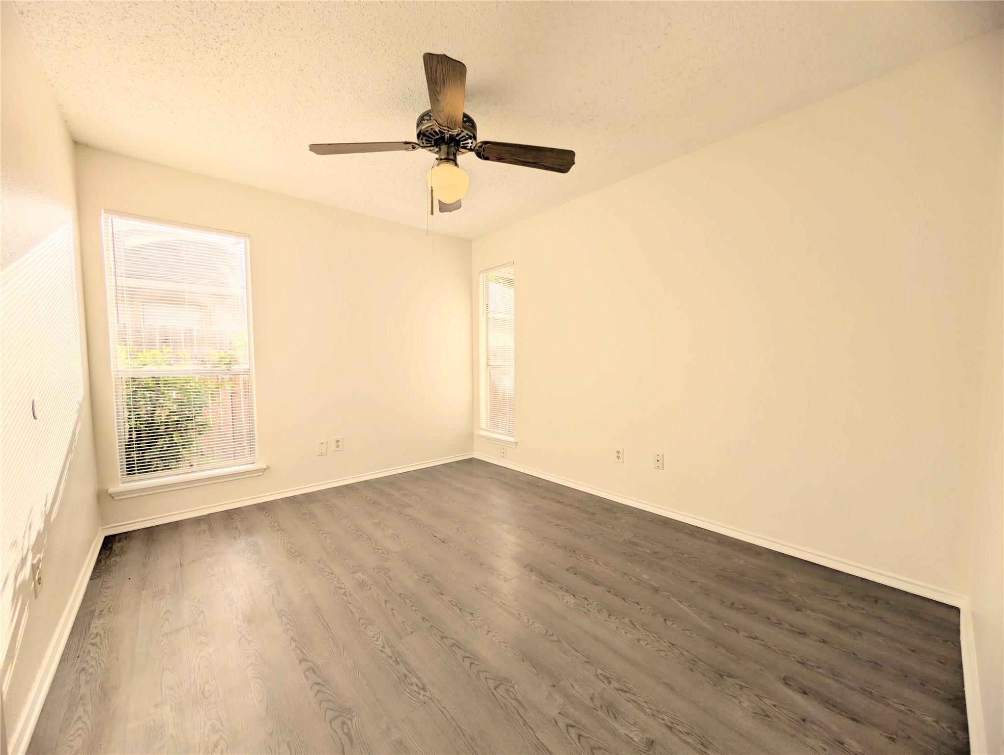 2016 Redwing Way Round Rock, TX 78664 - Photo 11 of 19 Bedroom #2:
A quiet bedroom featuring elegant wood flooring and well-lit with natural light from two windows.