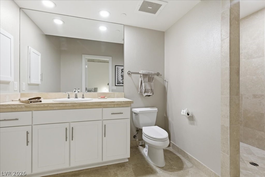 360 East Desert Inn Road, Unit 604 Las Vegas, NV 89109 - Photo 14 of 28 A pristine bathroom featuring a generously sized vanity and a practical commode, ready for your daily routine.