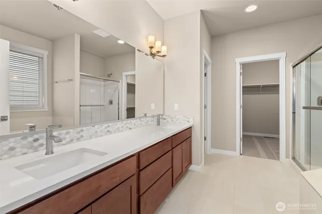 a bathroom with a tub a sink and a window