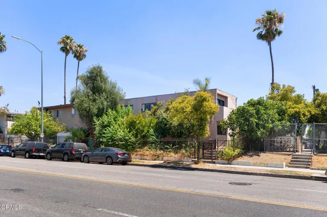 a couple of cars parked in front of a building