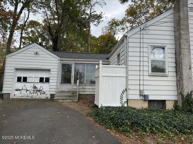 139 Walnut Drive Brick, NJ 08724 - Photo 12 of 15 a view of a white house with large windows and large tree