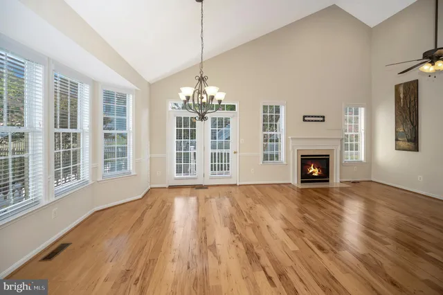 a view of a room with wooden floor and windows