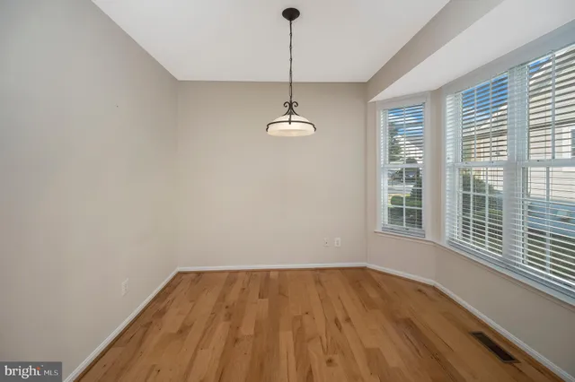 a spacious bedroom with a bed and a large window