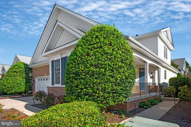 a view of a house with backyard sitting area and garden