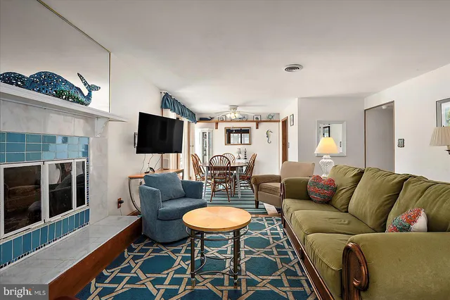 a living room with furniture a rug and a table