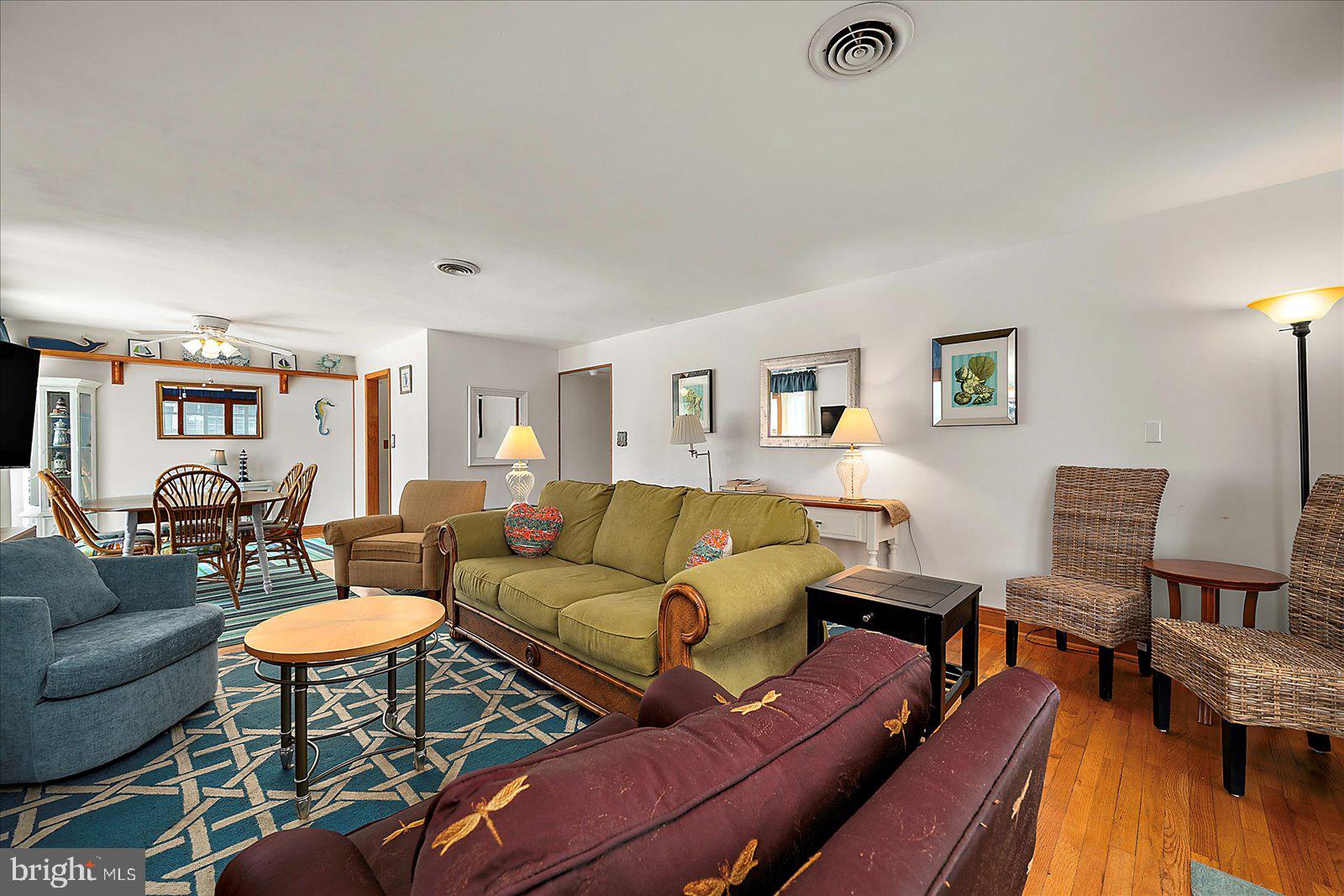 11602 Coastal Highway, Unit 1A Ocean City, MD 21842 - Photo 12 of 83 a living room with furniture a rug and a table