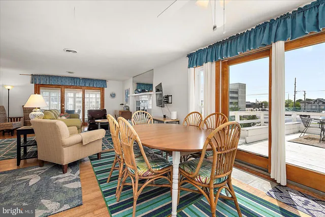 a dining room with furniture a chandelier and window