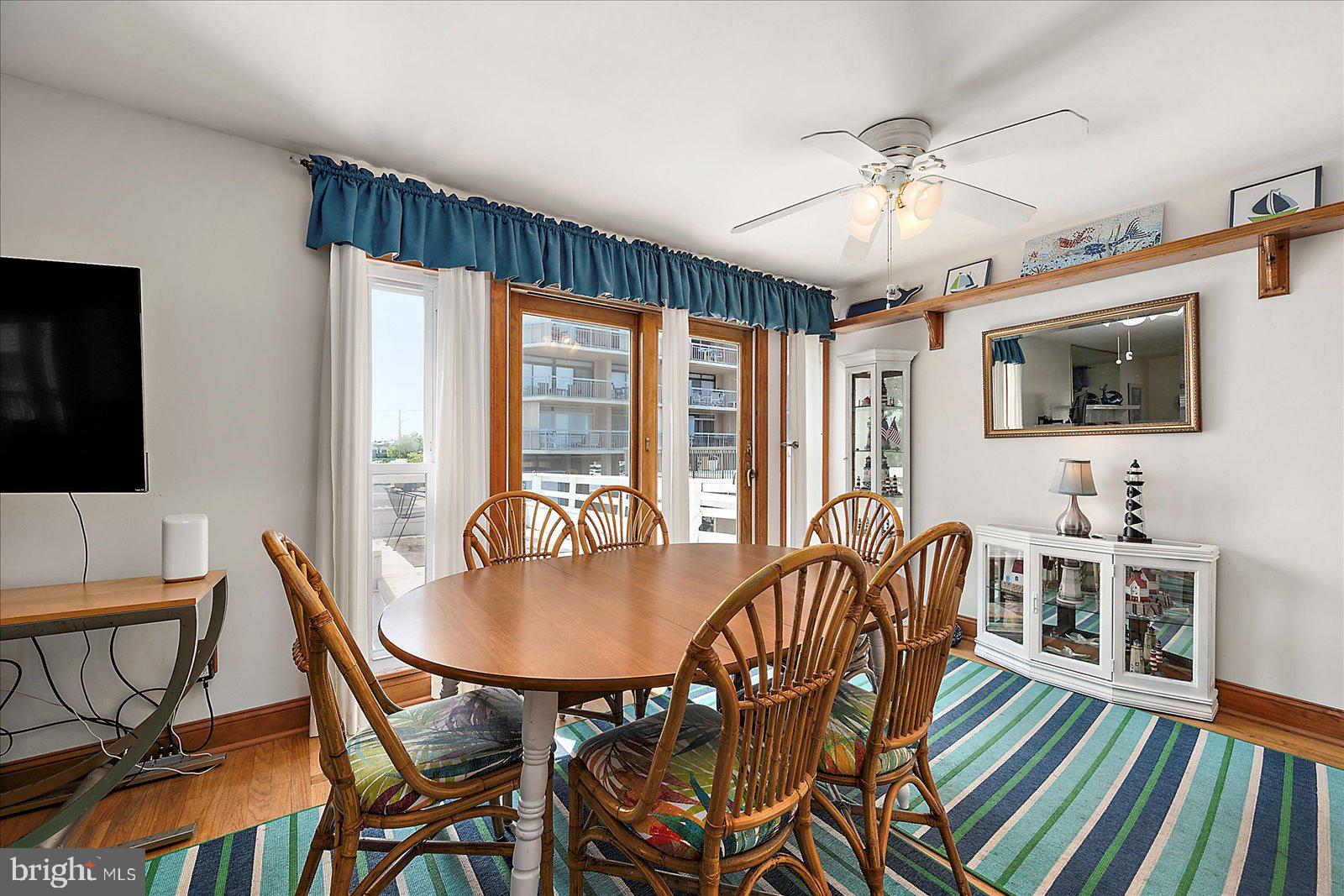 11602 Coastal Highway, Unit 1A Ocean City, MD 21842 - Photo 14 of 83 a dining room with furniture a chandelier and window