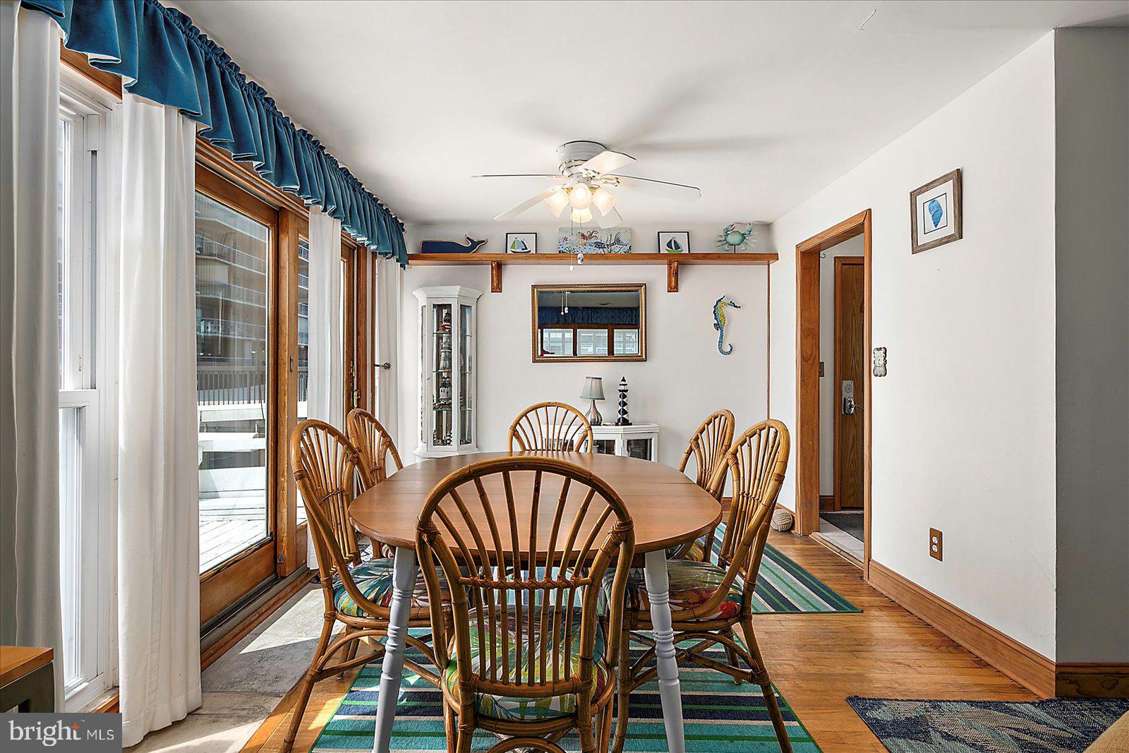 11602 Coastal Highway, Unit 1A Ocean City, MD 21842 - Photo 15 of 83 a view of a dining room with furniture window and wooden floor