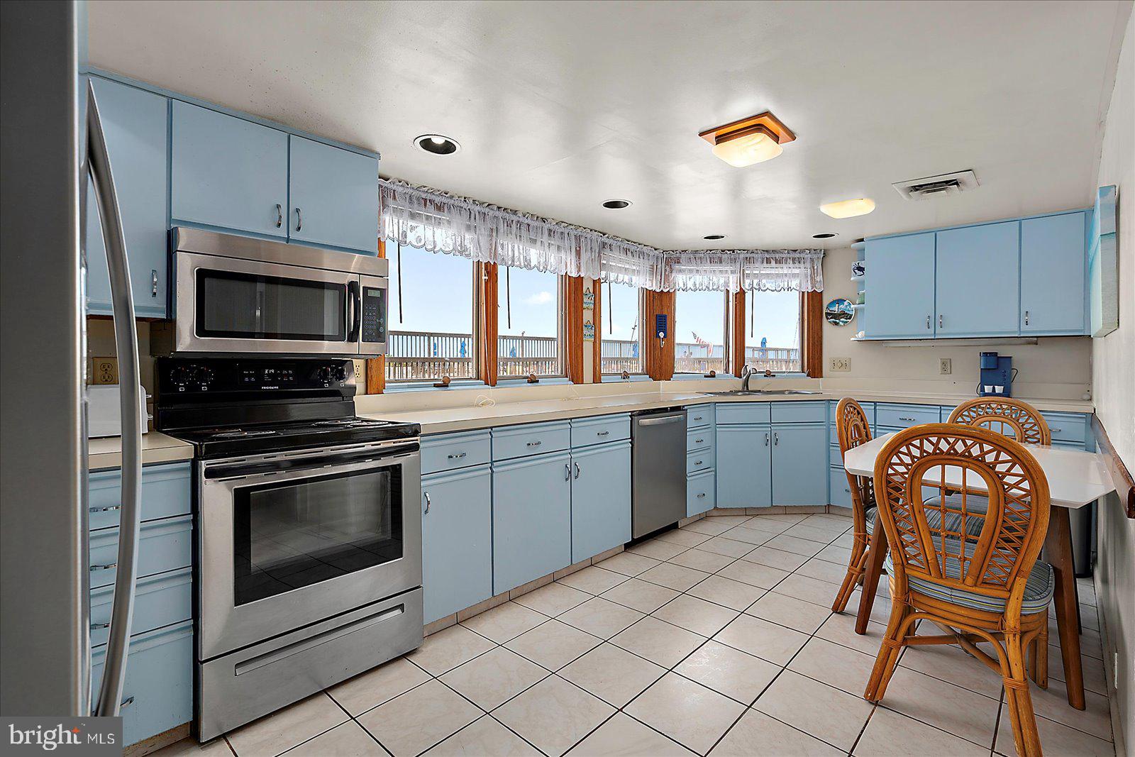 11602 Coastal Highway, Unit 1A Ocean City, MD 21842 - Photo 17 of 83 a kitchen with a stove a sink and a microwave