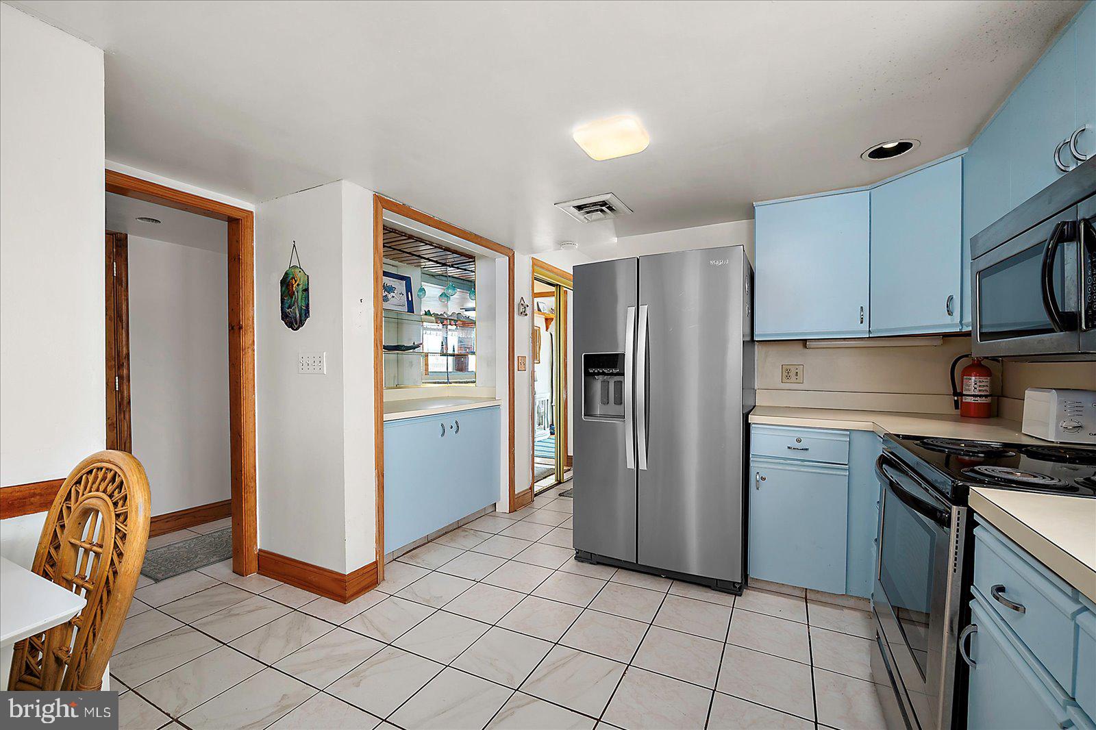 11602 Coastal Highway, Unit 1A Ocean City, MD 21842 - Photo 20 of 83 a kitchen with stainless steel appliances granite countertop a refrigerator and a stove top oven