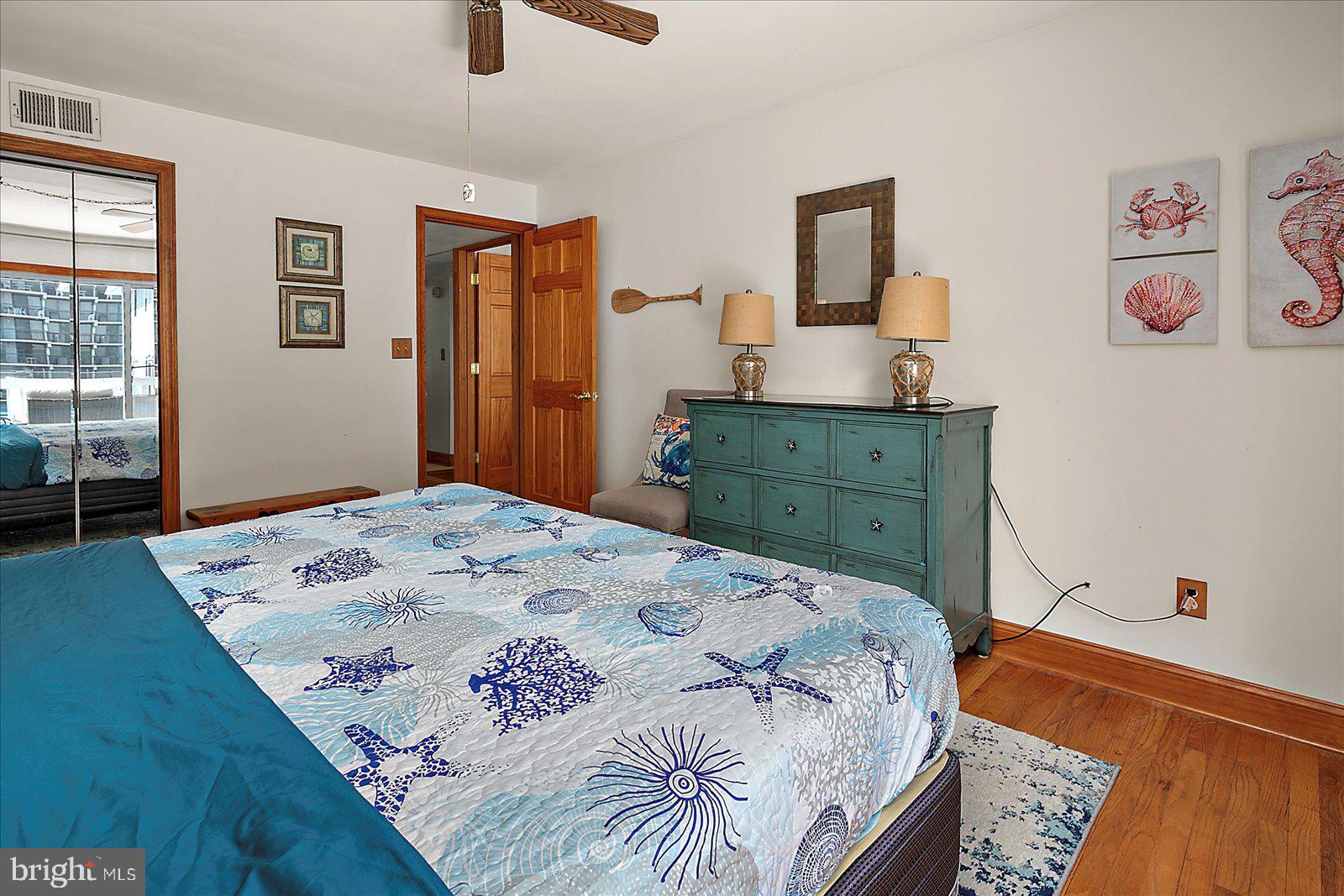 11602 Coastal Highway, Unit 1A Ocean City, MD 21842 - Photo 24 of 83 a bedroom with a bed and a dresser in it